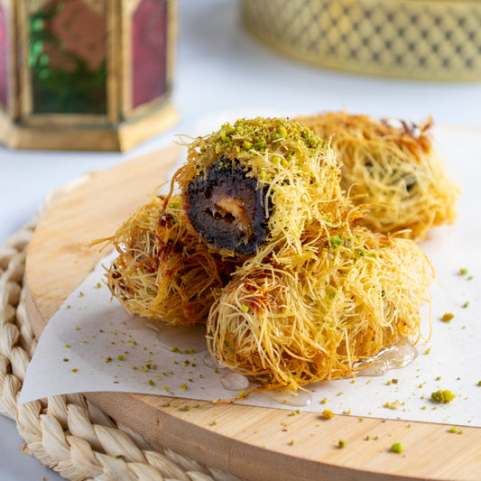 Dates Konafa Bites made with Linah Farms' Large Medjool Dates, konafa, and cream, served with sugar syrup and pistachios.