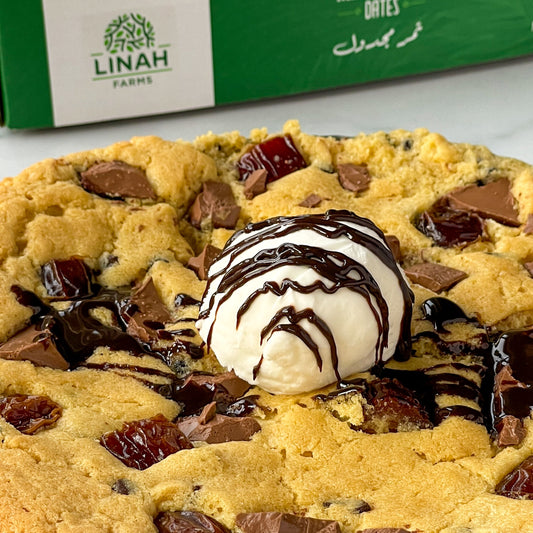 Gooey Dates Chocolate Chip Skillet Cookie with chunks of Large Medjool Dates and chocolate chips, served warm with a scoop of ice cream.