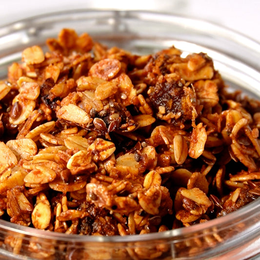 Crunchy Medjool Date Granola made with Large Medjool Dates, oats, flax seeds, chia seeds, and honey, served in a bowl.