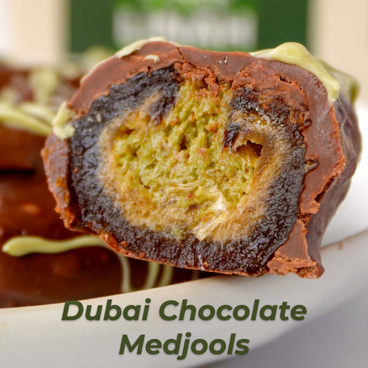 Luxury Dubai Chocolate Medjools filled with pistachio cream and kunafah dough, dipped in melted chocolate, served as a fancy treat.