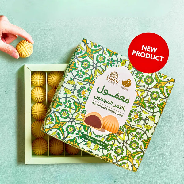 A golden box of Maamoul from Linah Farms in collaboration with The Cookievore, featuring beautifully arranged date-filled pastries.
