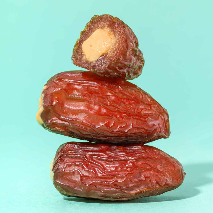 3 medjool dates stuffed with peanut butter on top of each other